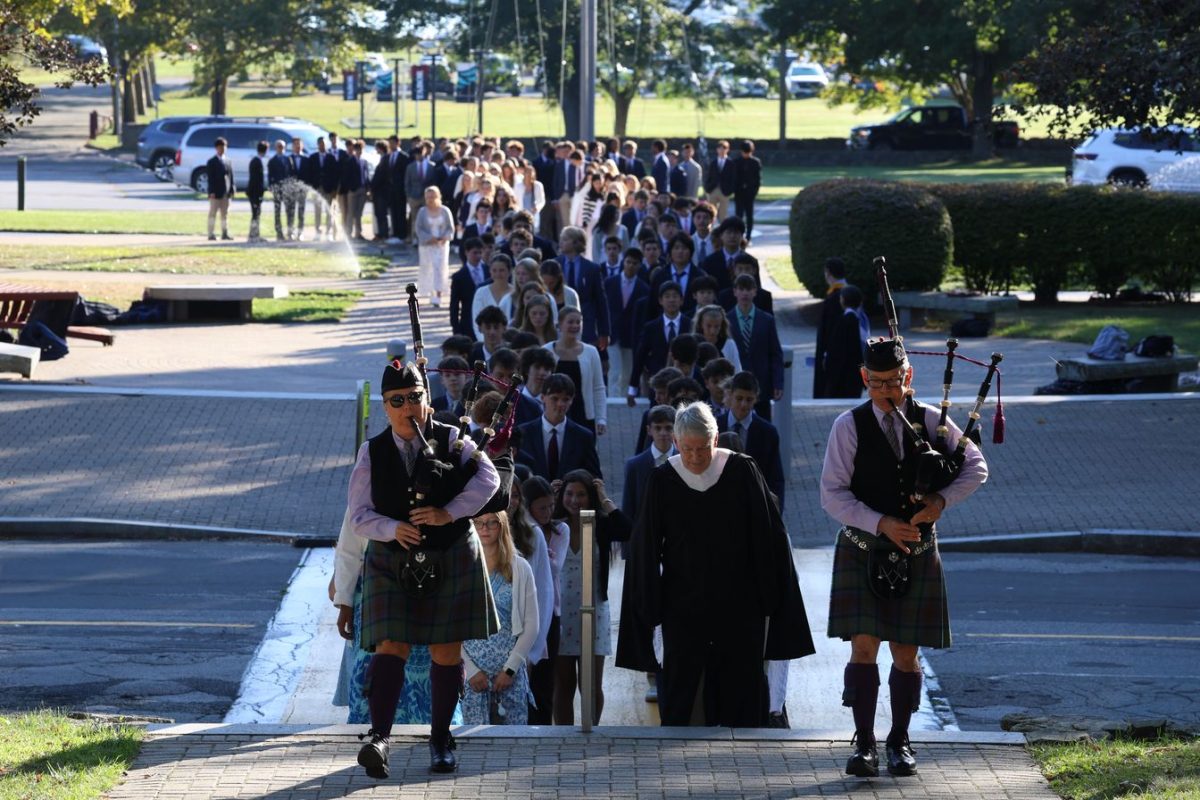 Hollybriar Bagpipers lead the ninth graders and the rest of the school into the chapel for Convocation.