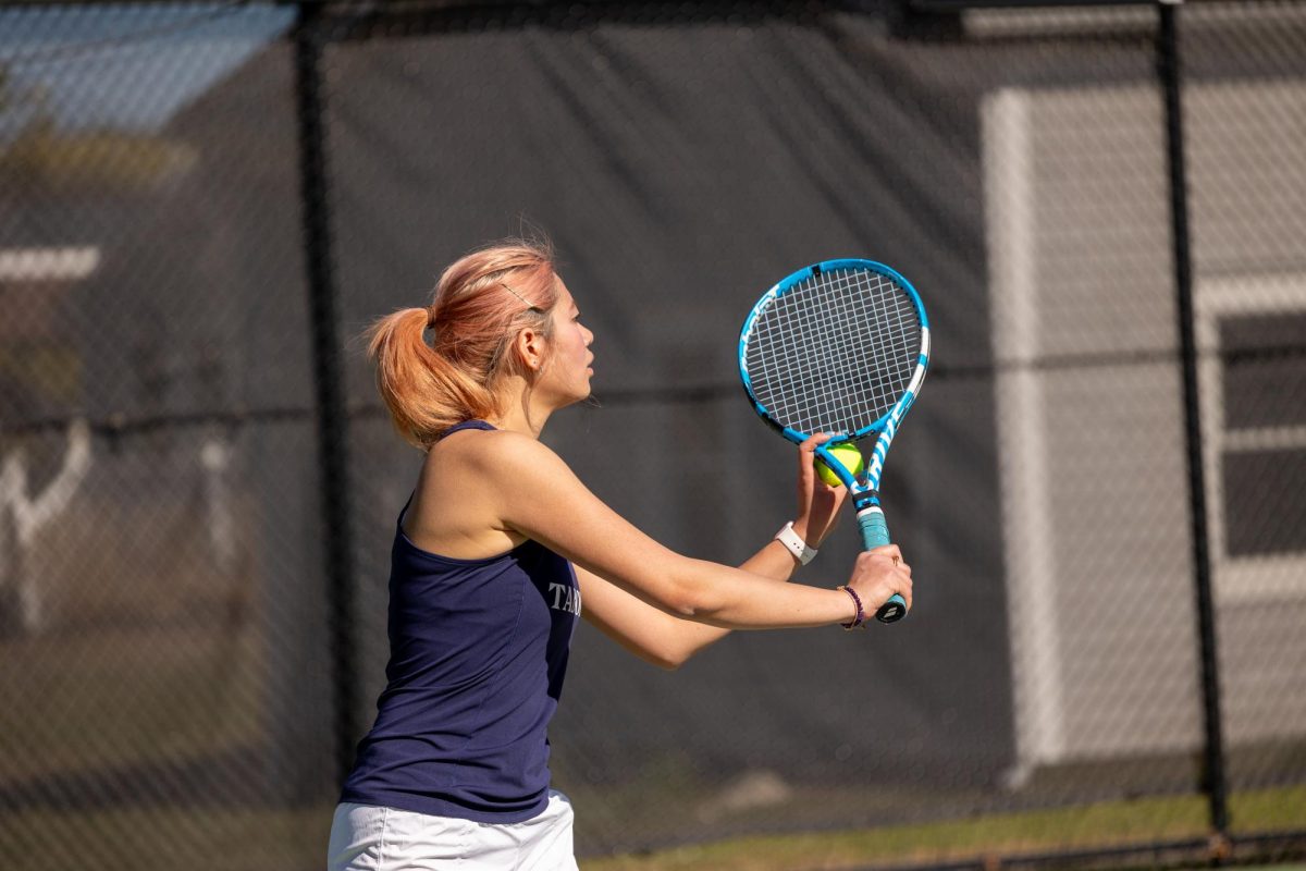 Tutu Hu '26 readies a serve against Governor's Academy on Saturday.